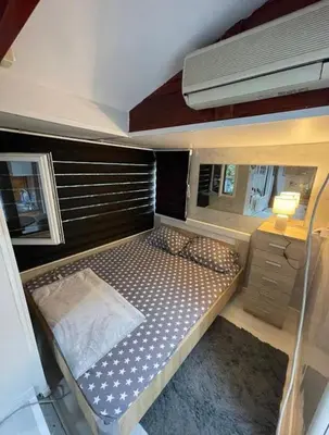 a bedroom with a bed in a small room at Kucica obala in Železnička Stanica Zeta