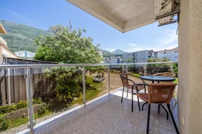 a balcony with a table and chairs on it at Vanila Apartmani in Sutomore