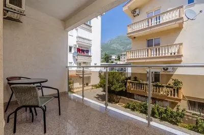 a balcony in a building with a table and chair at Vanila Apartmani in Sutomore