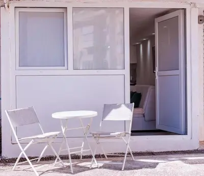 two chairs and a table in front of a window at Mia Studio Apartment in Budva