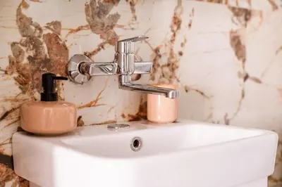 a bathroom sink with a soap dispenser on it at Mia Studio Apartment in Budva