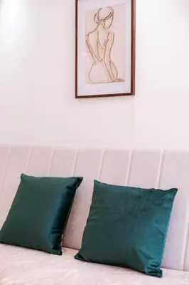 two green pillows sitting on top of a couch at Mia Studio Apartment in Budva