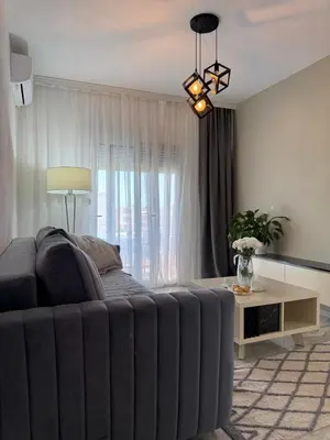 a living room with a couch and a table at Best Apartments in Ulcinj