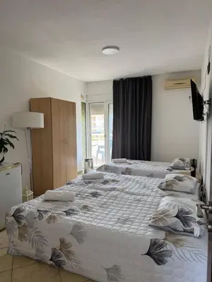 a bedroom with a large bed with pillows on it at Best Apartments in Ulcinj