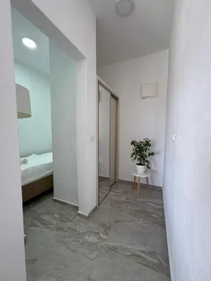 a room with a bed and a potted plant in it at Best Apartments in Ulcinj