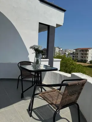 a table and two chairs on a balcony with a table at Best Apartments in Ulcinj