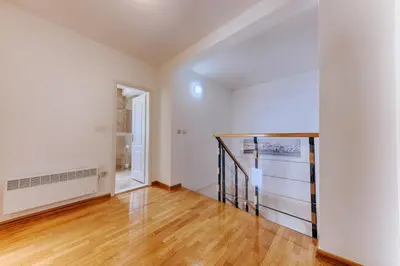 an empty room with a staircase and a window at Three bedrooms family apartment with sea view Sveti Stefan in Sveti Stefan