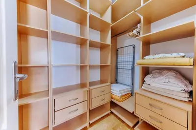 a walk in closet with wooden shelves at Three bedrooms family apartment with sea view Sveti Stefan in Sveti Stefan