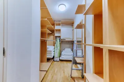 a room with wooden shelves and a hallway with towels at Three bedrooms family apartment with sea view Sveti Stefan in Sveti Stefan