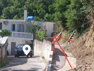 a car is parked in front of a house at White apartment in Sutomore