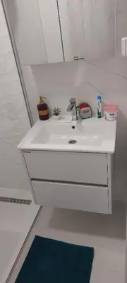 a white sink with a faucet in a bathroom at White apartment in Sutomore