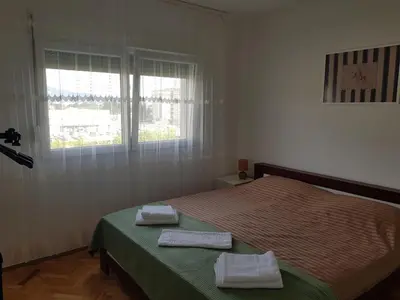 a bedroom with a bed with two towels on it at Spacious and comfortable apartment in Podgorica