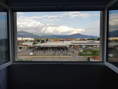 a view of a parking lot from a window at Spacious and comfortable apartment in Podgorica