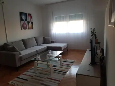a living room with a couch and a coffee table at Spacious and comfortable apartment in Podgorica