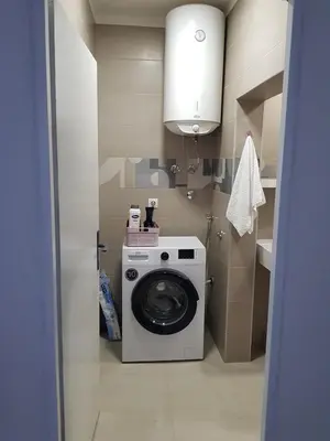 a washer and dryer in a small bathroom at Spacious and comfortable apartment in Podgorica