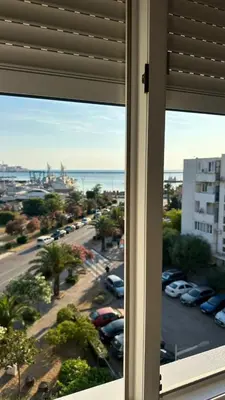 a window with a view of a parking lot at Porta Mare Apartment in Bar