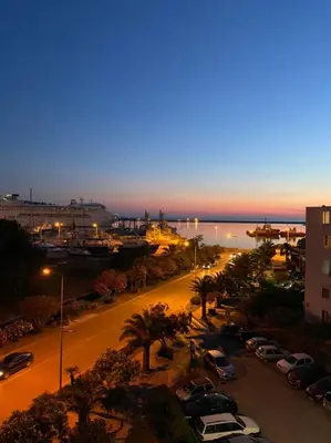 a city street with cars parked in a parking lot at Porta Mare Apartment in Bar
