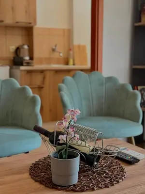 a table with a pot with a flower on it at Porta Mare Apartment in Bar