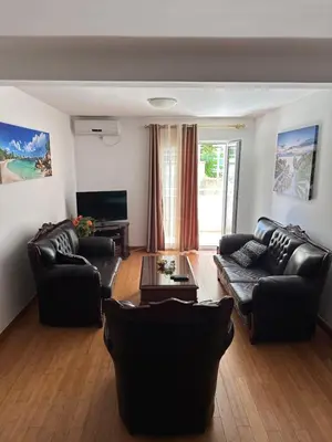 a living room with two couches and a table at Summer Dreams Apartment in Budva