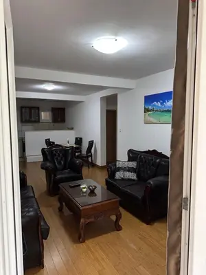 a living room with black leather furniture and a table at Summer Dreams Apartment in Budva