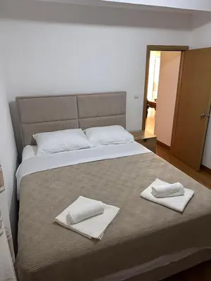 a bedroom with a bed with two towels on it at Summer Dreams Apartment in Budva