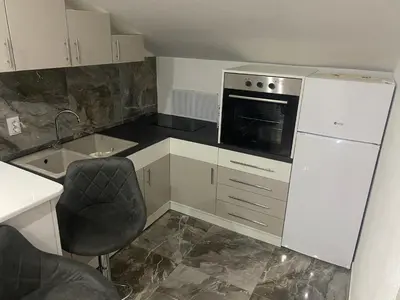 a small kitchen with a sink and a microwave at Bayview Apartments in Drobnići