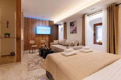 a hotel room with a bed and a couch at Avenza Residences Kotor Old Town in Kotor