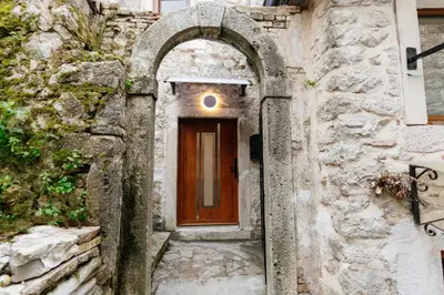 an entrance to a building with a wooden door at Avenza Residences Kotor Old Town in Kotor