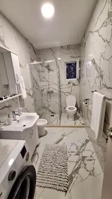 a bathroom with a shower and a toilet and a sink at Milovic Apartman in Kotor