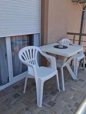 a white table and two chairs on a patio at Milovic Apartman in Kotor