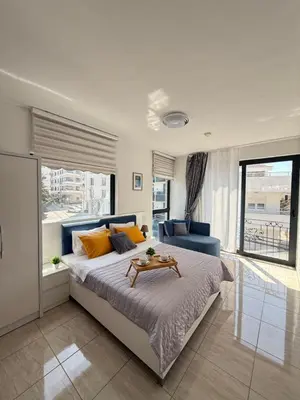 a bedroom with a large bed with a table on it at Adam & Eve Family Apartment in Dobra Voda