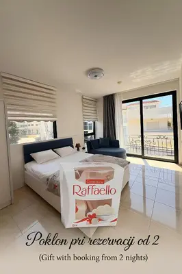 a pizza box sitting on a bed in a bedroom at Adam & Eve Family Apartment in Dobra Voda