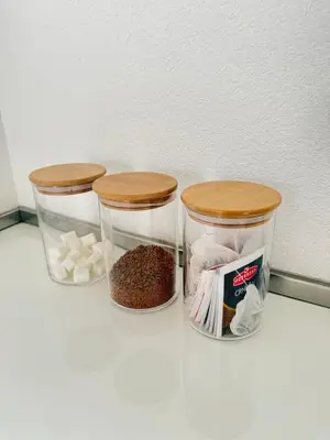 three containers of food sitting on top of a refrigerator at Adam & Eve Family Apartment in Dobra Voda