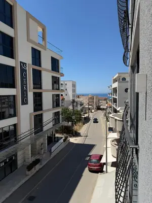 a view of a street from a balcony of a building at Adam & Eve Family Apartment in Dobra Voda