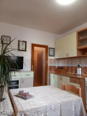 a kitchen with a table with a white table cloth at Apartman Centar in Petrovac na Moru