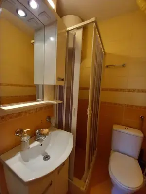 a bathroom with a sink and a toilet at Apartman Centar in Petrovac na Moru