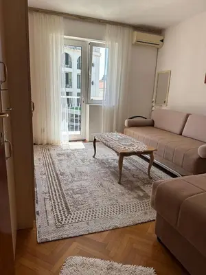 a living room with a couch and a coffee table at Apartman Centar in Petrovac na Moru