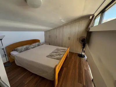 a small bedroom with a bed and a window at Royal Central Apartment in Bar