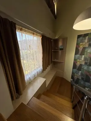 a small room with a window and a stair case at Royal Central Apartment in Bar