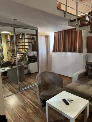 a living room with a couch and a chair at Royal Central Apartment in Bar