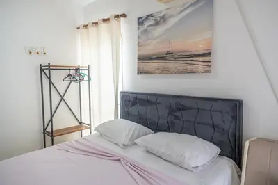 a bed with two white pillows and a picture on the wall at Beach Center in Ulcinj