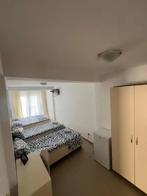 a small bedroom with a bed and a window at Apartmani MalaPlaza in Ulcinj