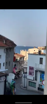 a city street with buildings and the ocean in the background at Apartmani MalaPlaza in Ulcinj