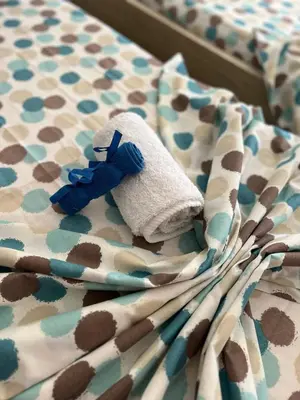 a stuffed animal sitting on top of a bed at Apartmani MalaPlaza in Ulcinj