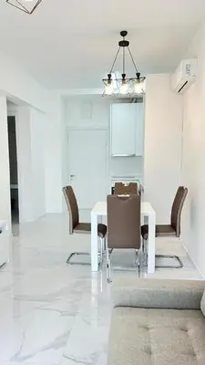 a dining room with a white table and chairs at Apartment Del Mare in Boreti