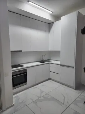 a white kitchen with a sink and a stove at Apartment Del Mare in Boreti