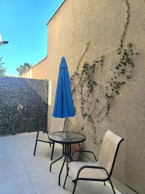 two chairs and a table and an umbrella on a patio at Apartment Del Mare in Boreti