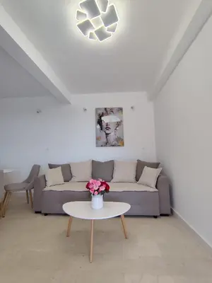 a living room with a couch and a table at Apartment NS in Bar