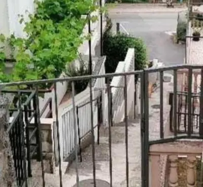 a balcony with a black railing and a street at Nina Apartment 5 in Budva