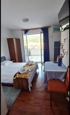 a bedroom with two beds and a balcony at Nina Apartment 5 in Budva